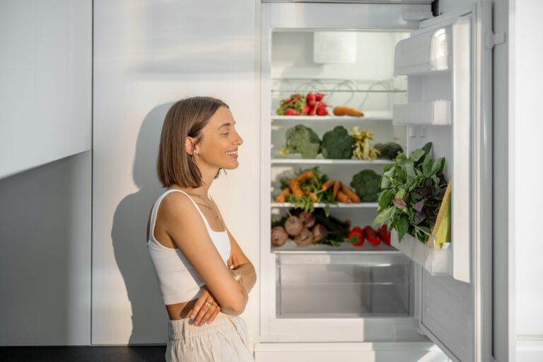 Woman with healthy vegetables in the fridge