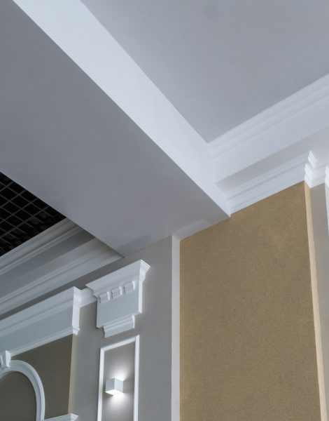 Detail of corner ceiling with intricate crown molding on column with spot light