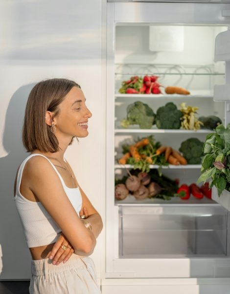 Woman with healthy vegetables in the fridge